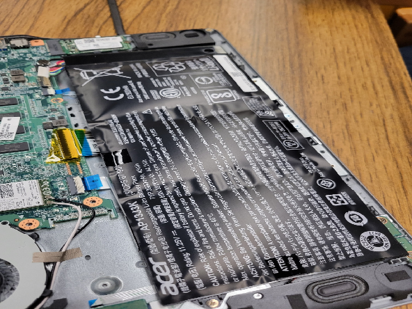 Disassembled Chromebook with swollen battery.